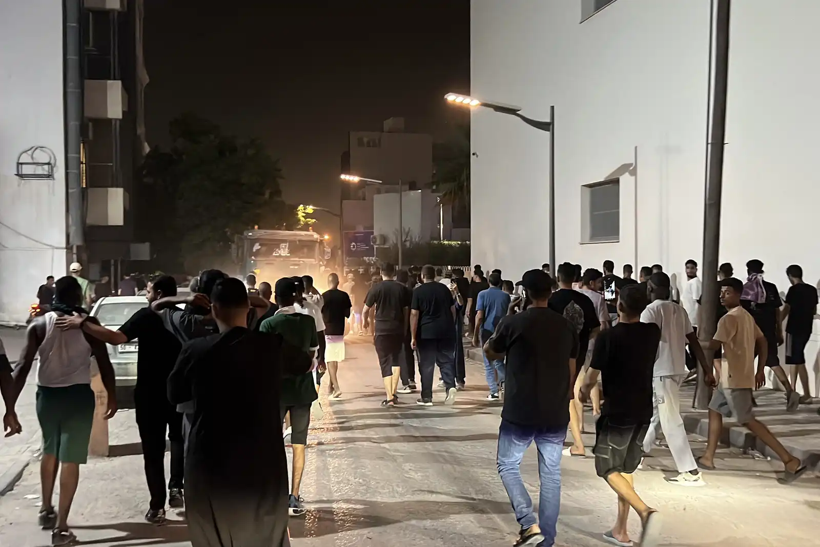 اشخاص يتجمعون خارج مباني شركات تابعة للمؤسسة الوطنية للنفط في ليبيا، في حي الزهراء بطرابلس، بسبب انقطاع التيار الكهربائي اليومي في أنحاء البلاد، يوم 28 يوليو 2026