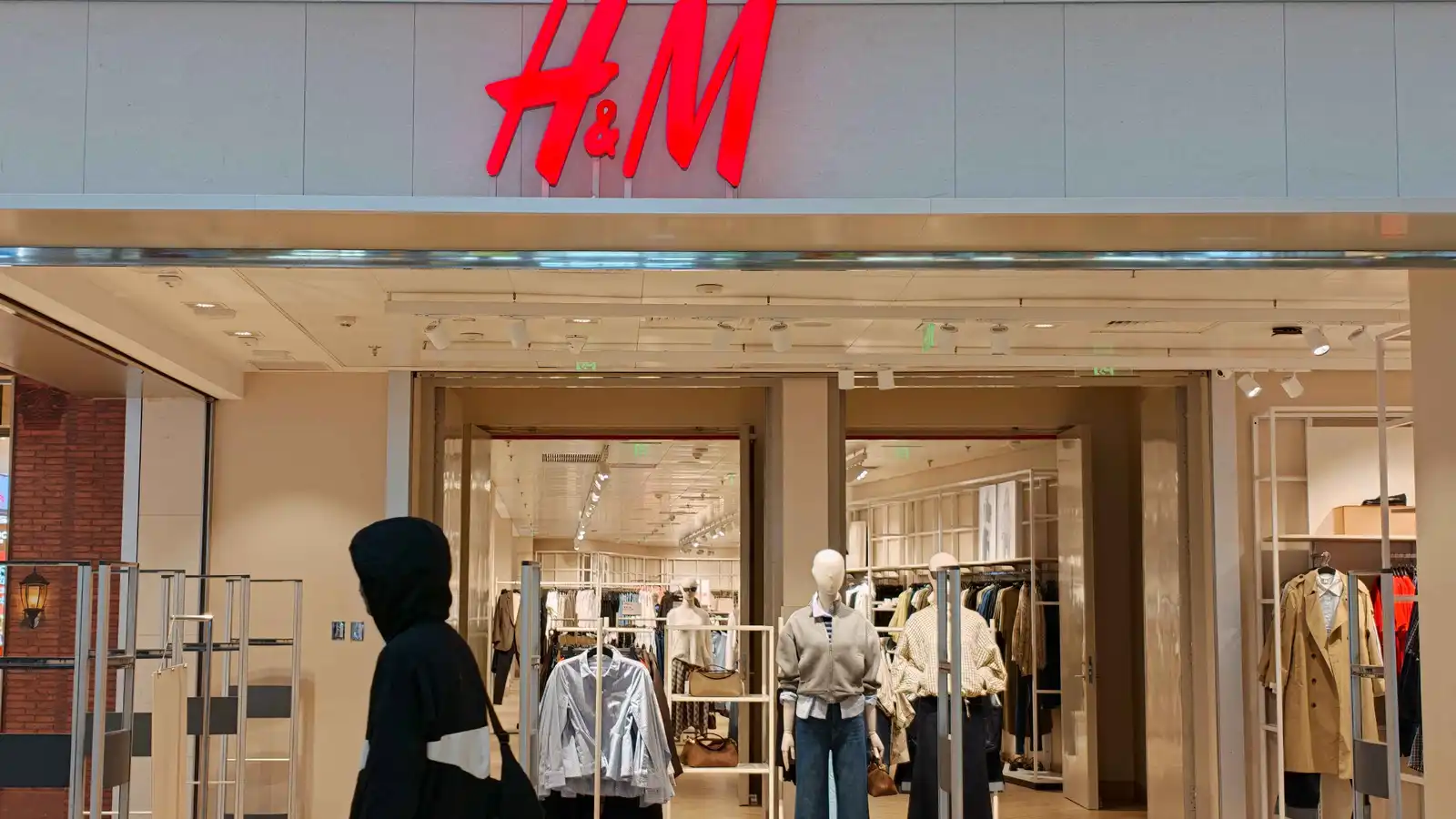 مارة  أمام متجر ملابس تابع لعلامة إتش آند إم (H&M) في مركز تجاري بمنطقة بودونغ في شنغهاي بالصين، في 10 سبتمبر 2026.