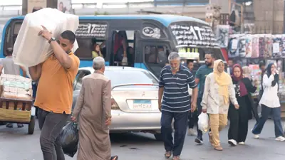 مواطنون يسيرون في أحد الشوارع المزدحمة بالعاصمة المصرية القاهرة يوم 5 أكتوبر 2024