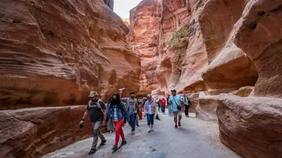 سياح يتجولون في مدينة البترا القديمة جنوبي الأردن يوم 12 ديسمبر 2022
