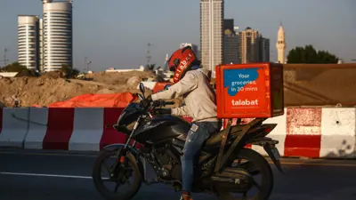 عامل توصيل تابع لشركة «طلبات» على دراجته عبر أحد طرق دبي -  الإمارات يوم 29 نوفمبر 2023.